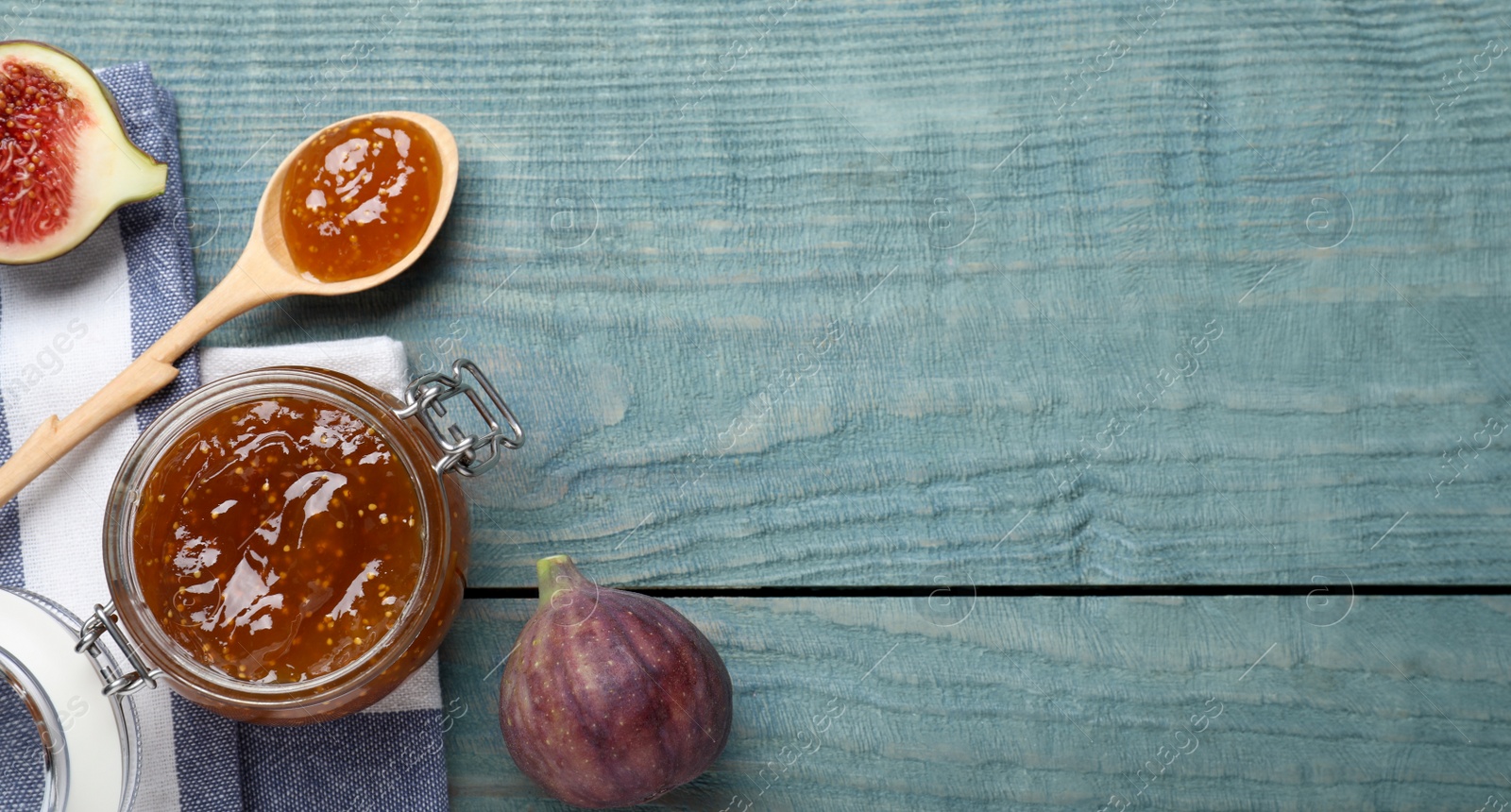 Photo of Flat lay composition with homemade delicious fig jam on blue wooden table. Space for text