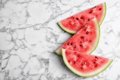 Photo of Slices of watermelon on marble background, top view