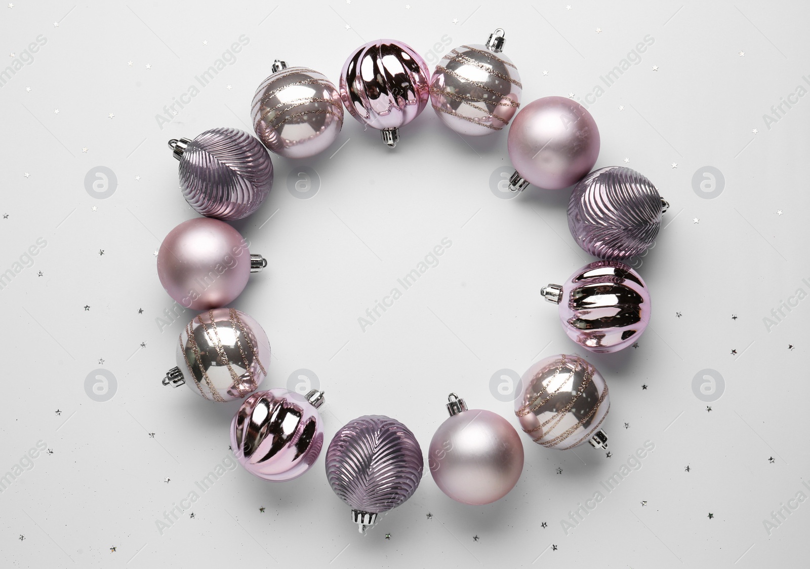 Photo of Beautiful festive wreath made of color Christmas balls on white background, top view