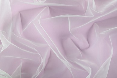 Photo of Beautiful tulle fabric on lilac background, top view