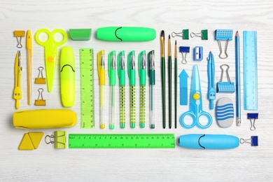 Flat lay composition with different school stationery on wooden background