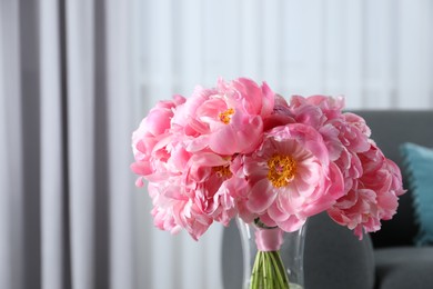 Beautiful bouquet of pink peonies in vase indoors