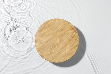 Photo of Presentation for product. Wooden podium in water on white background, top view