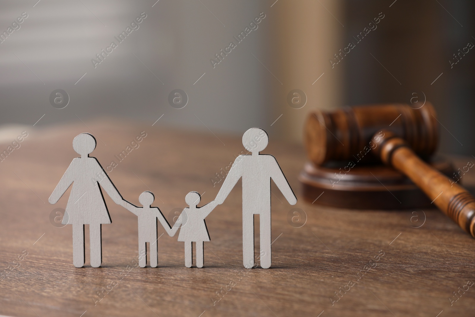 Photo of Family law. Figure of parents with children and gavel on wooden table, space for text