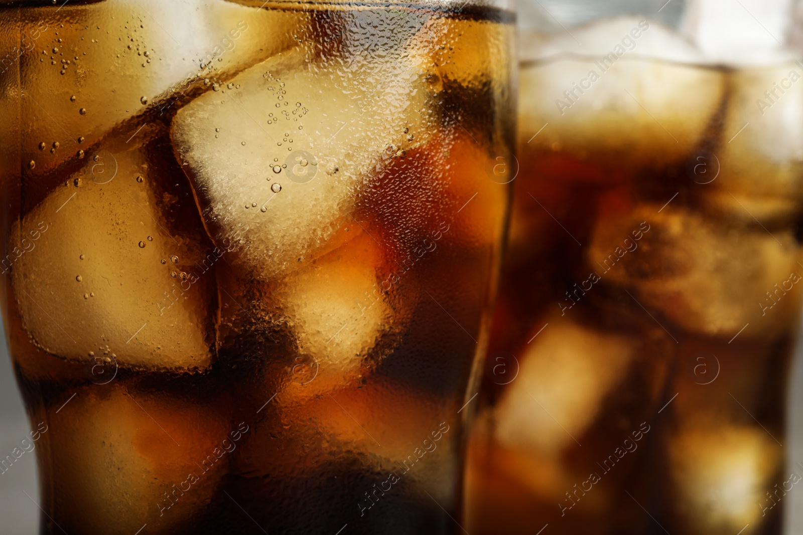 Photo of Glasses of refreshing soda drinks with ice cubes, closeup