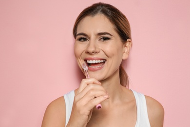 Photo of Portrait of woman with toothbrush on color background