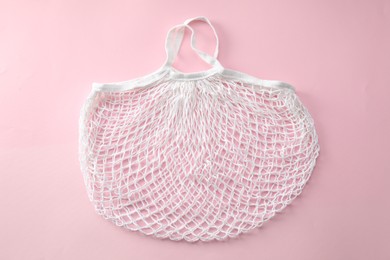 Photo of White string bag on pink background, top view
