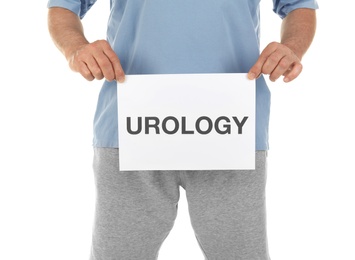 Photo of Mature man holding paper with word UROLOGY on white background