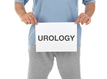 Mature man holding paper with word UROLOGY on white background