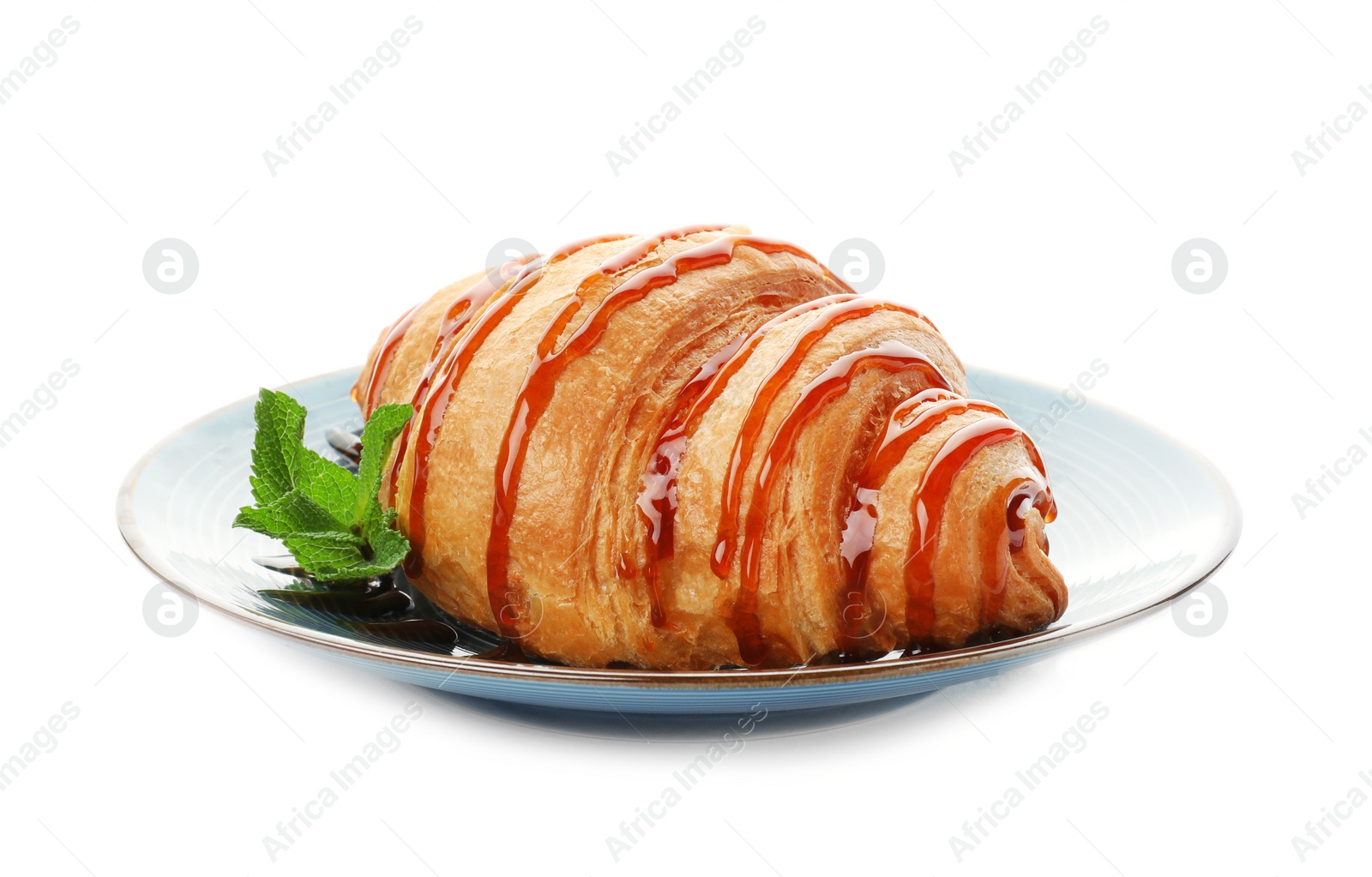 Photo of Tasty croissant with sauce on plate against white background