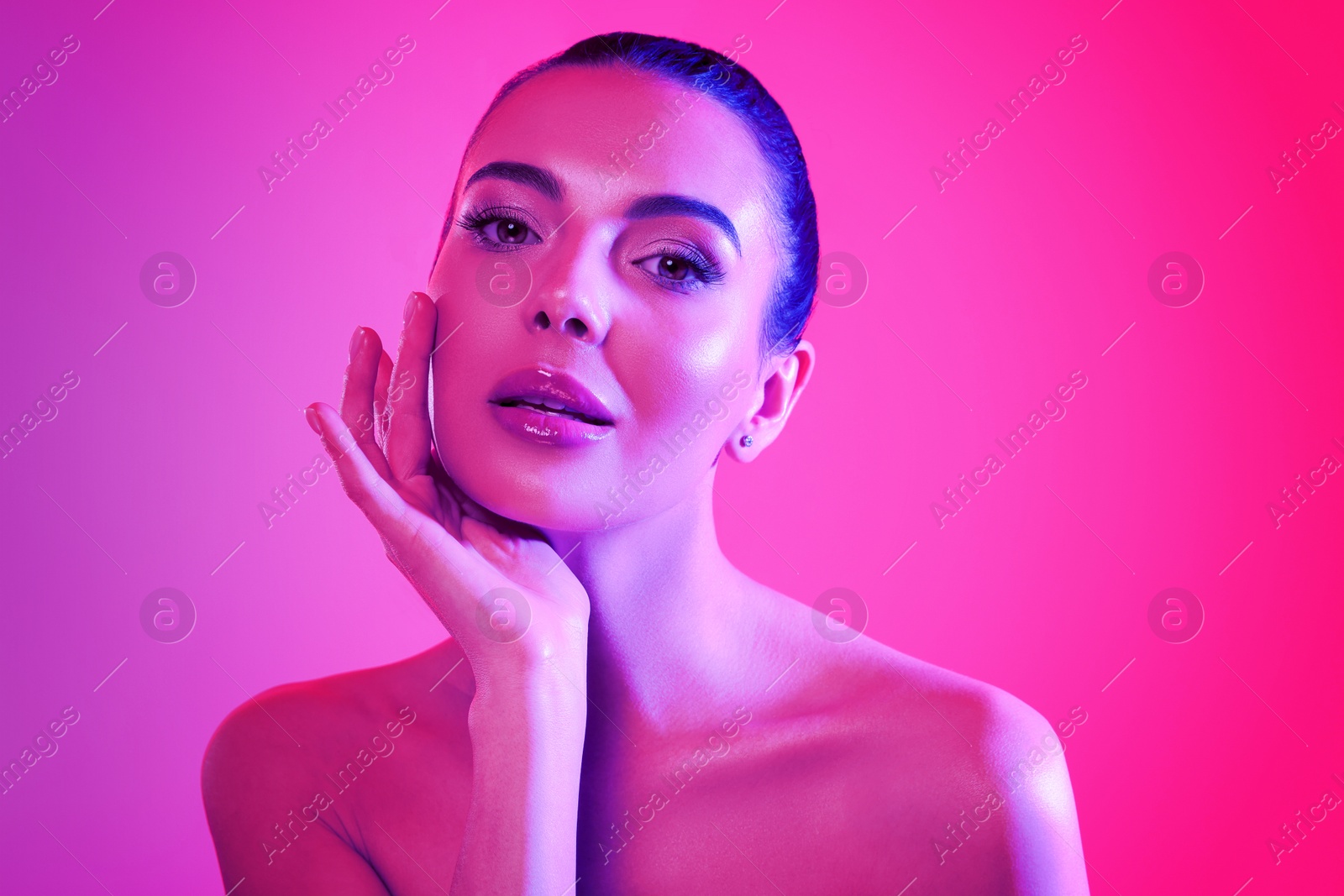 Image of Portrait of beautiful woman posing in neon lights