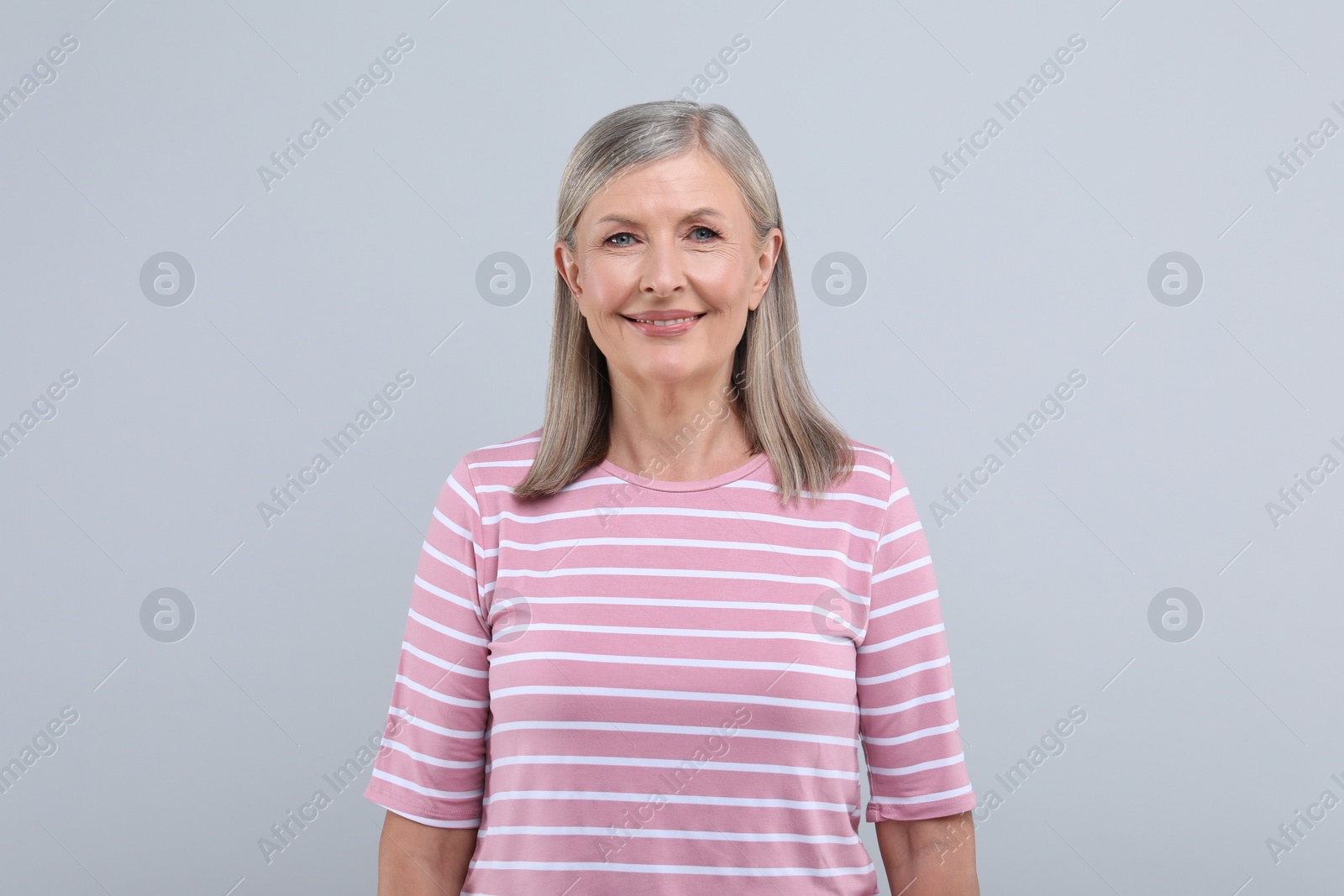 Photo of Portrait of beautiful senior woman on light grey background