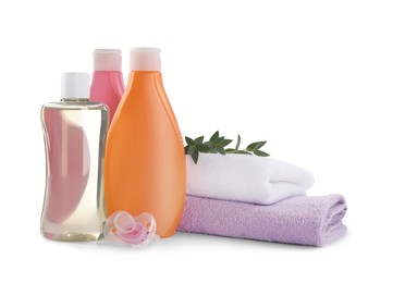 Bottle of baby oil, other cosmetic products and accessories on white background