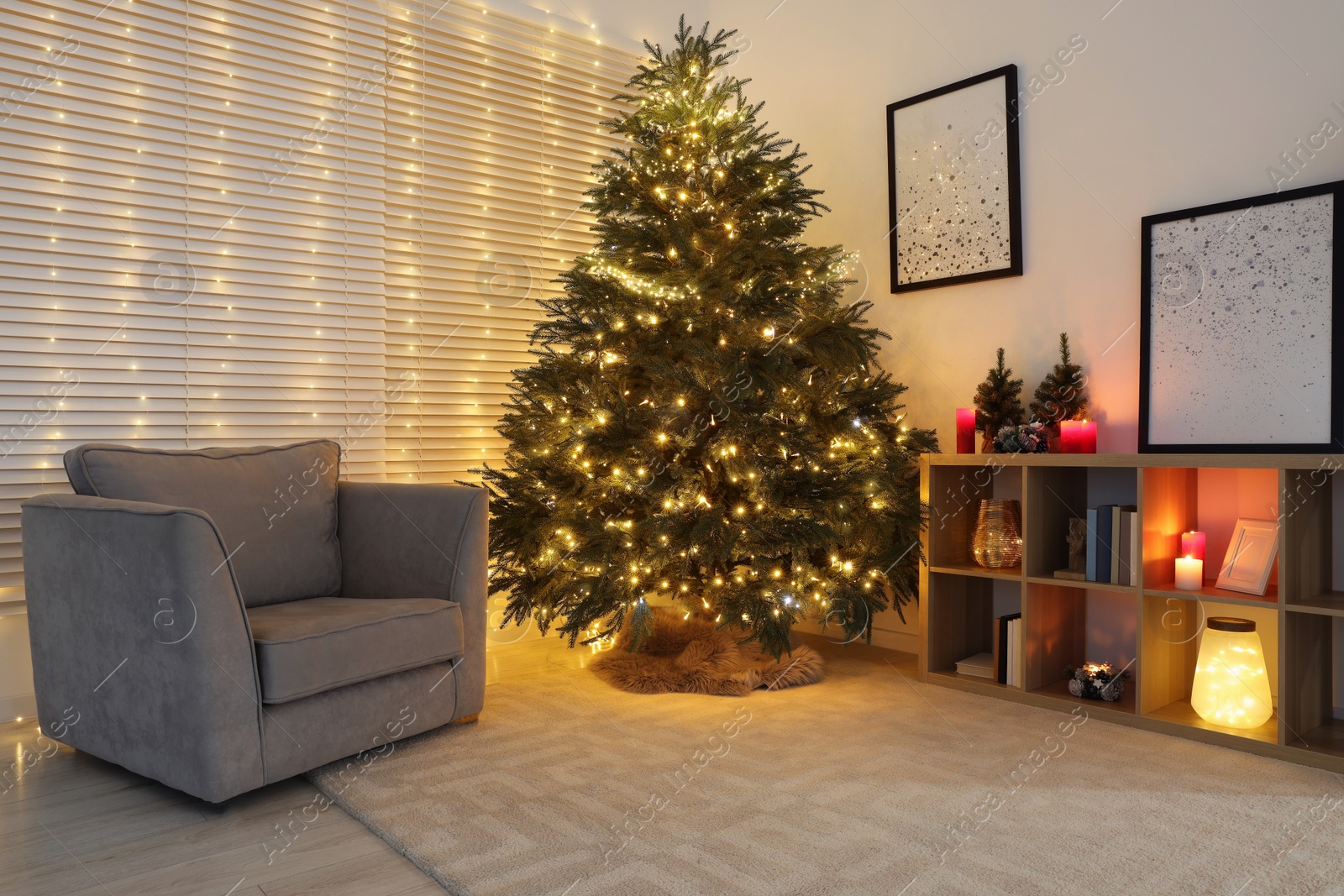 Photo of Beautiful Christmas tree with golden lights in living room