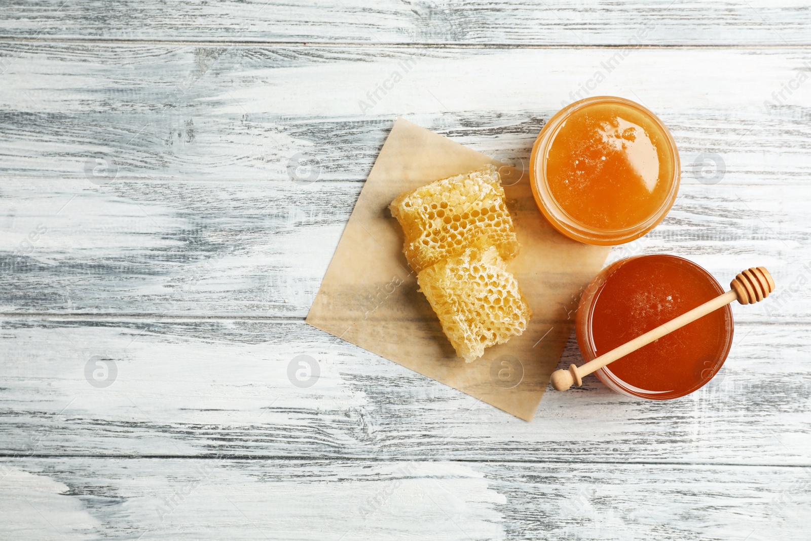 Photo of Flat lay composition with fresh honey on wooden background