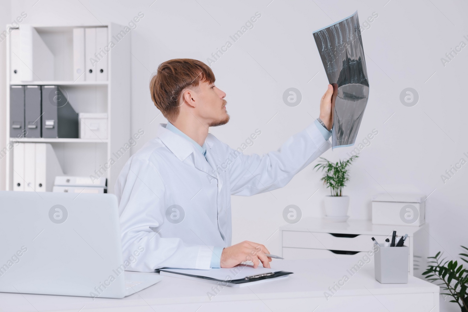 Photo of Doctor examining neck MRI image in clinic