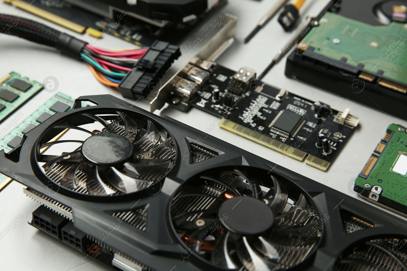 Photo of Graphics card and other computer hardware on gray background, closeup