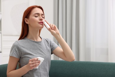 Photo of Medical drops. Woman with tissue using nasal spray at home, space for text