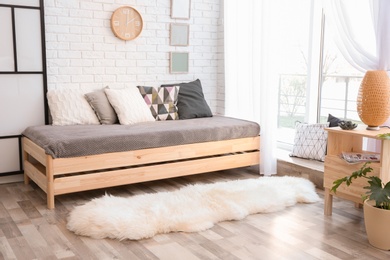 Modern living room interior with wooden furniture and furry carpet