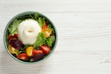 Photo of Delicious burrata salad with colorful cherry tomatoes and arugula on white wooden table, top view. Space for text