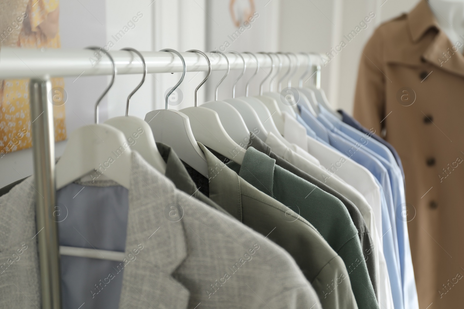 Photo of Collection of stylish woman's clothes in modern boutique, closeup