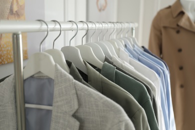 Photo of Collection of stylish woman's clothes in modern boutique, closeup