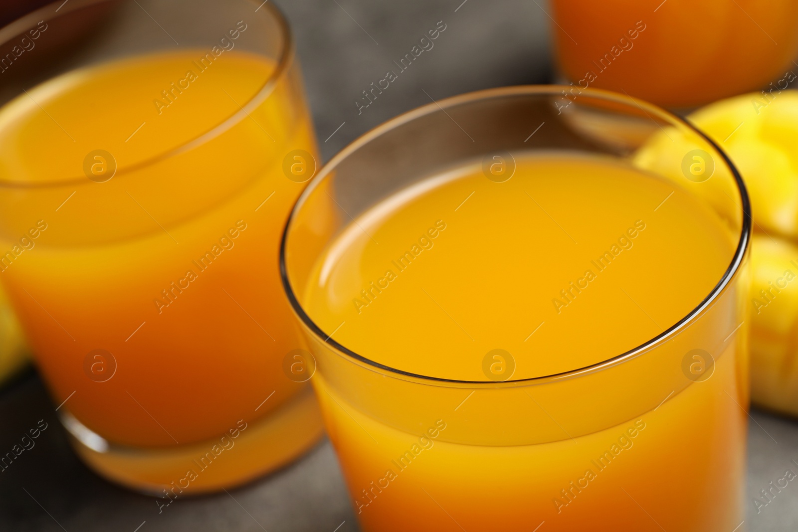 Photo of Fresh delicious mango drink on table, closeup