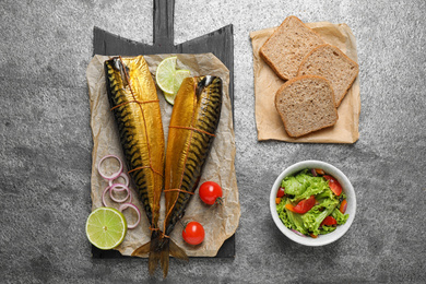 Photo of Flat lay composition with tasty smoked fish on grey table