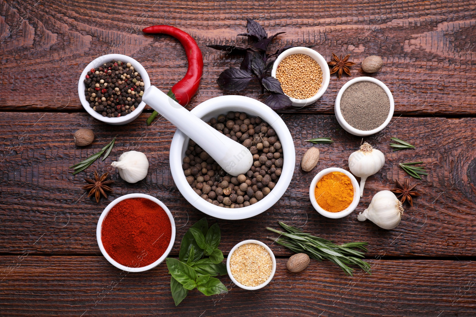 Photo of Flat lay composition with mortar and different spices on wooden table