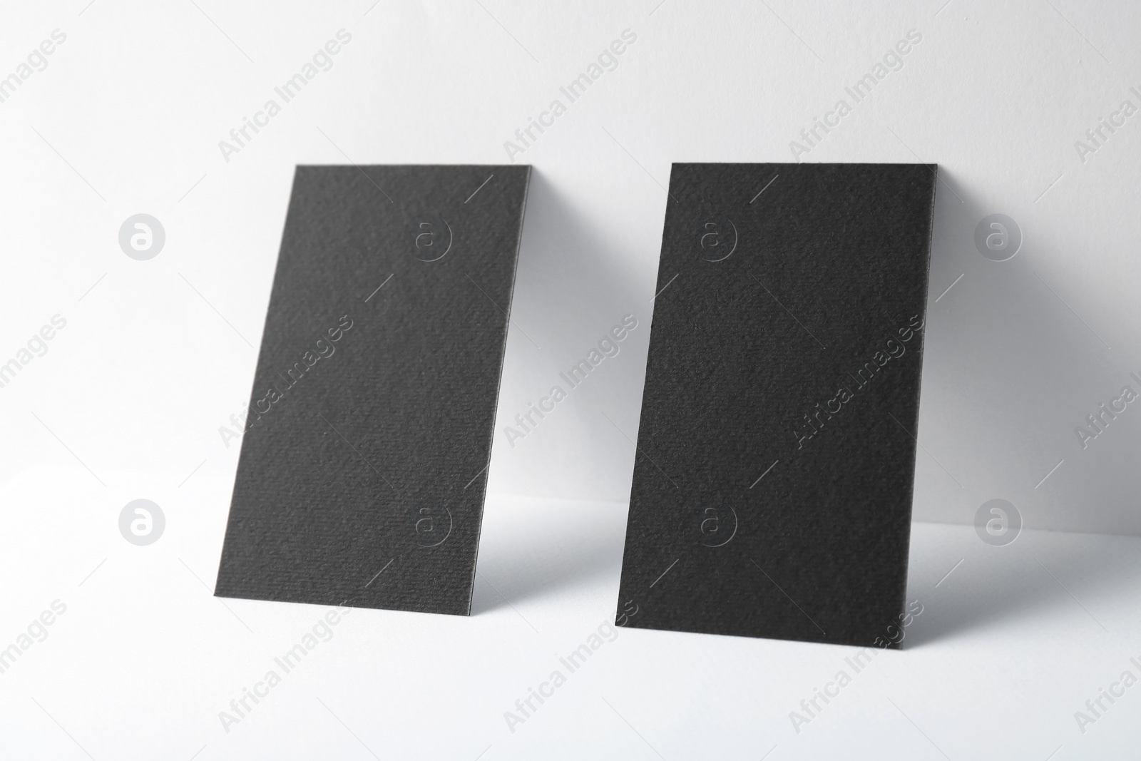 Photo of Blank black business cards on white background. Mockup for design