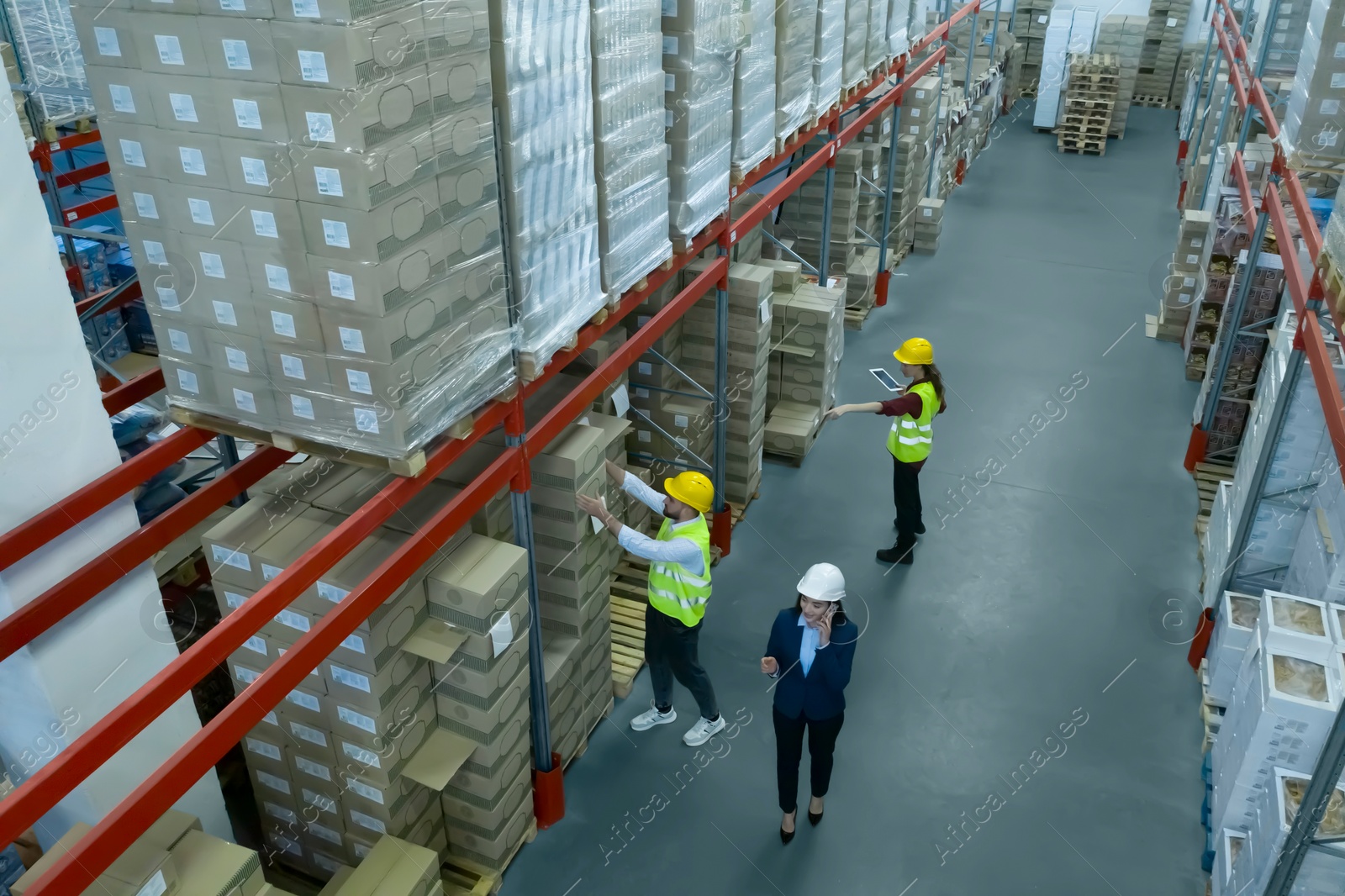 Image of Manager and workers at warehouse, above view. Logistics center