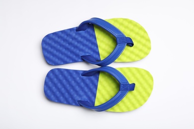 Photo of Pair of flip flops on white background, top view. Beach accessories