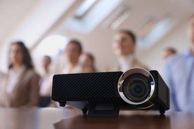 Photo of Modern video projector on table during conference