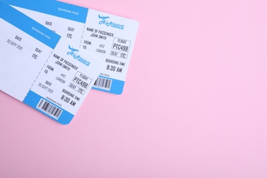 Photo of Tickets on pink background, flat lay with space for text. Travel agency concept
