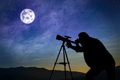 Image of Astronomer looking at moon and stars through telescope outdoors