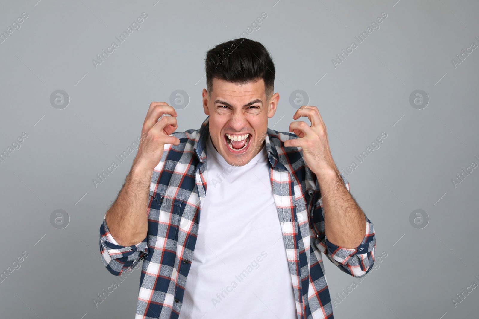 Photo of Portrait of emotional man on light grey background. Personality concept