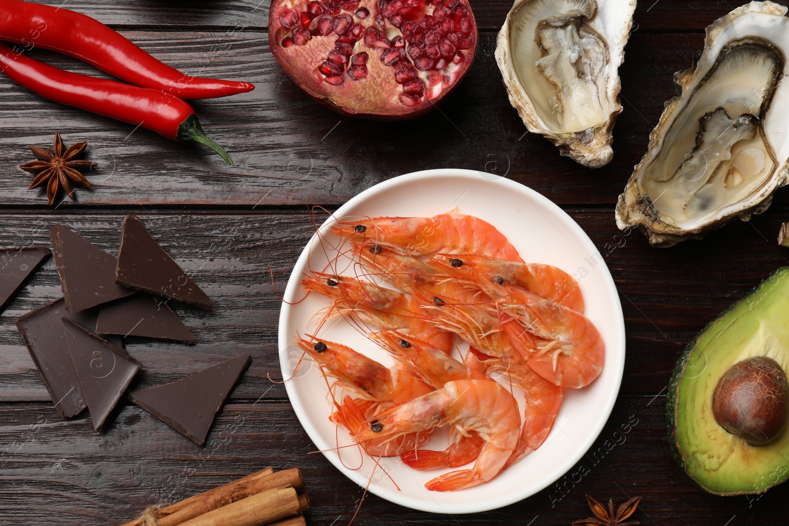 Photo of Natural aphrodisiac. Different food products on dark wooden table, flat lay