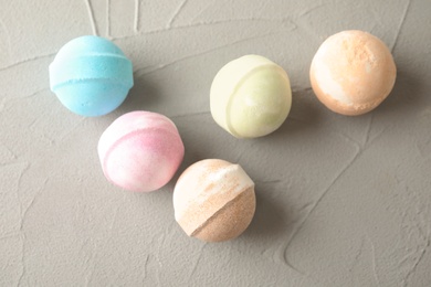 Photo of Colorful bath bombs on grey background, top view