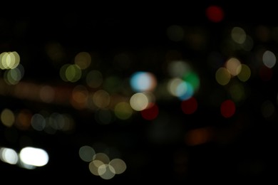 Photo of Blurred view of colorful glowing lights outdoors, bokeh effect