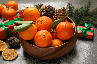 Christmas composition with fresh tangerines on grey background