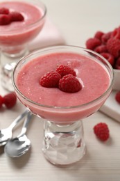 Delicious raspberry mousse on white wooden table