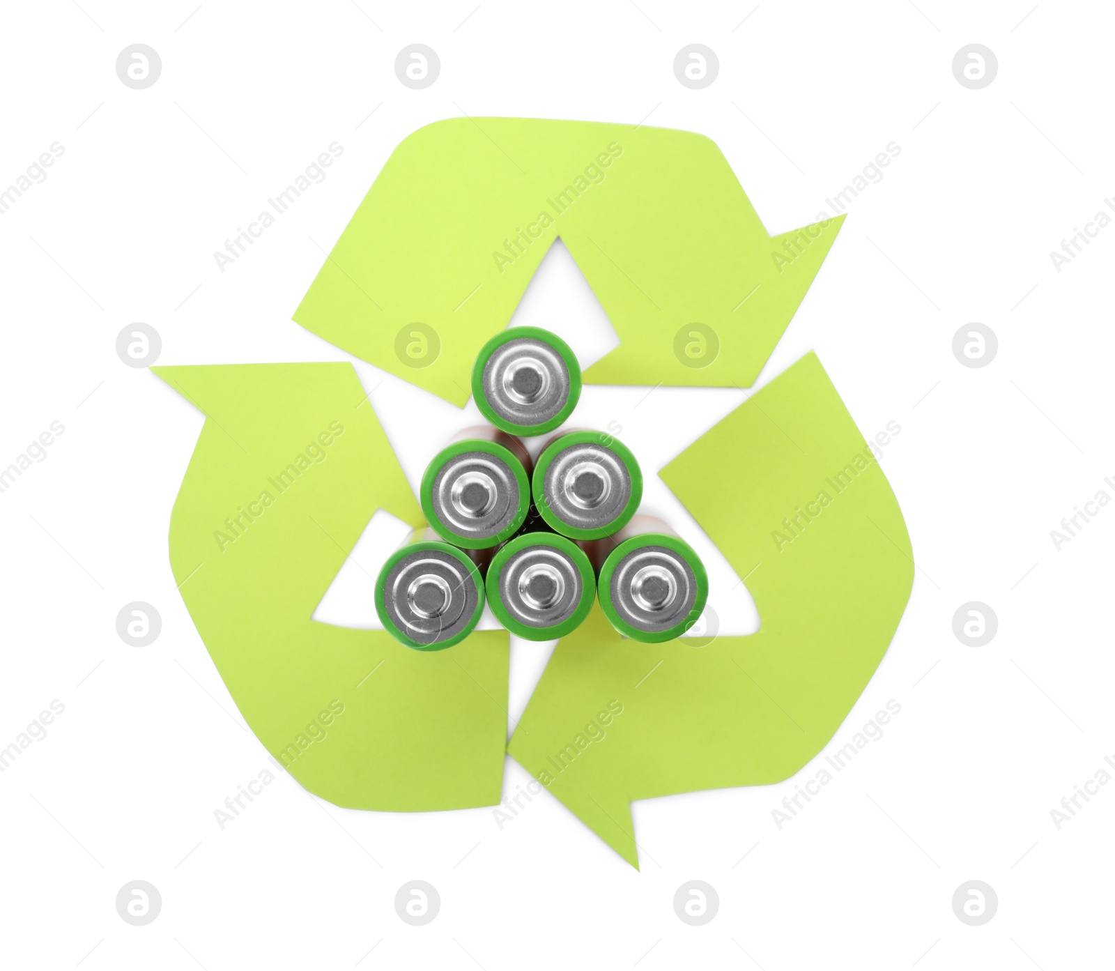 Photo of Used batteries and recycling symbol on white background, top view