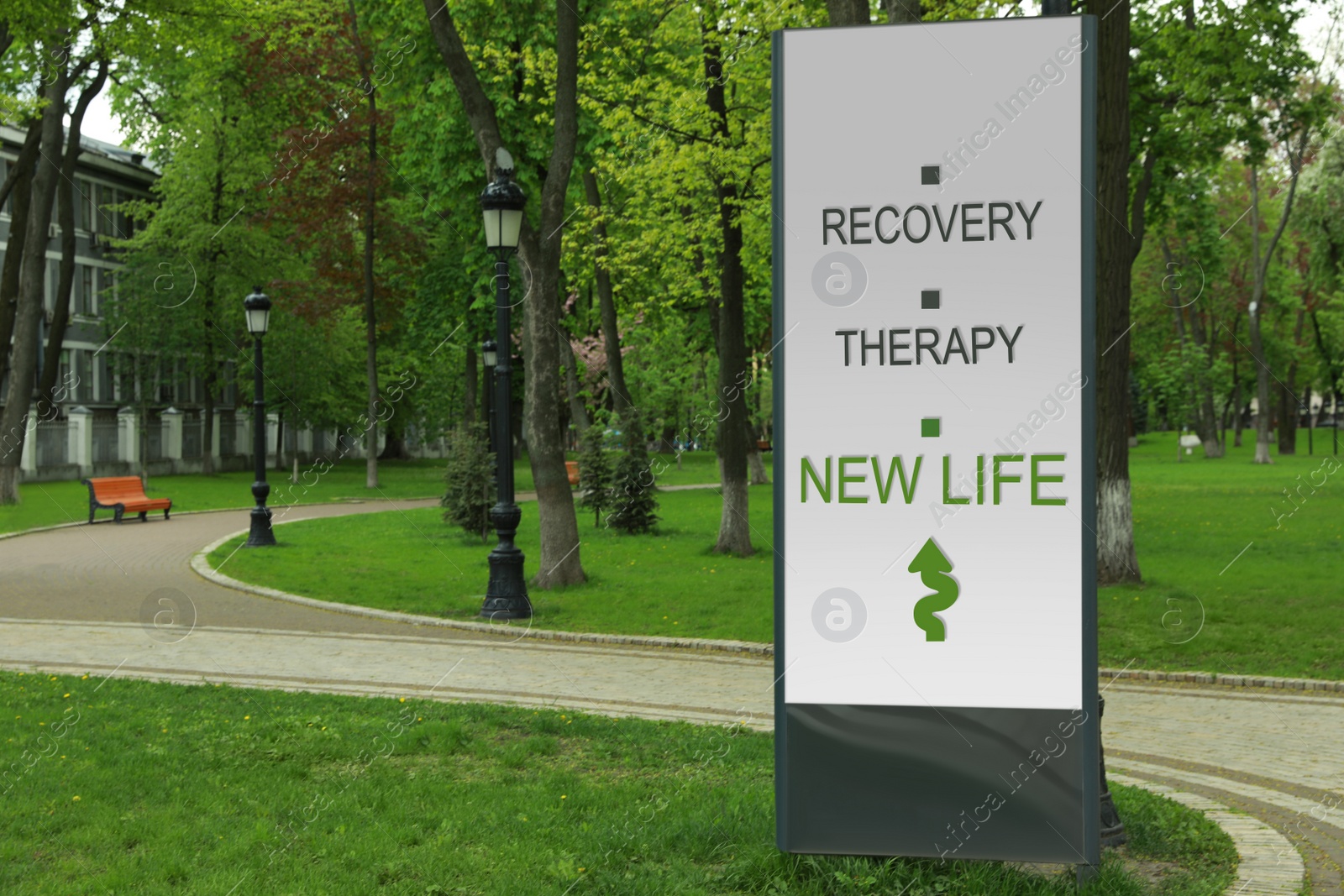 Image of Start to live without alcohol addiction. Advertising board with inscription RECOVERY, THERAPY AND NEW LIFE  in park