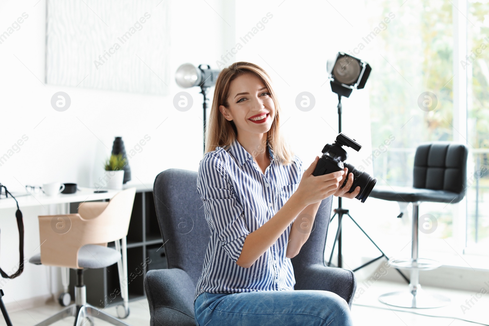 Photo of Portrait of female photo blogger with camera at home