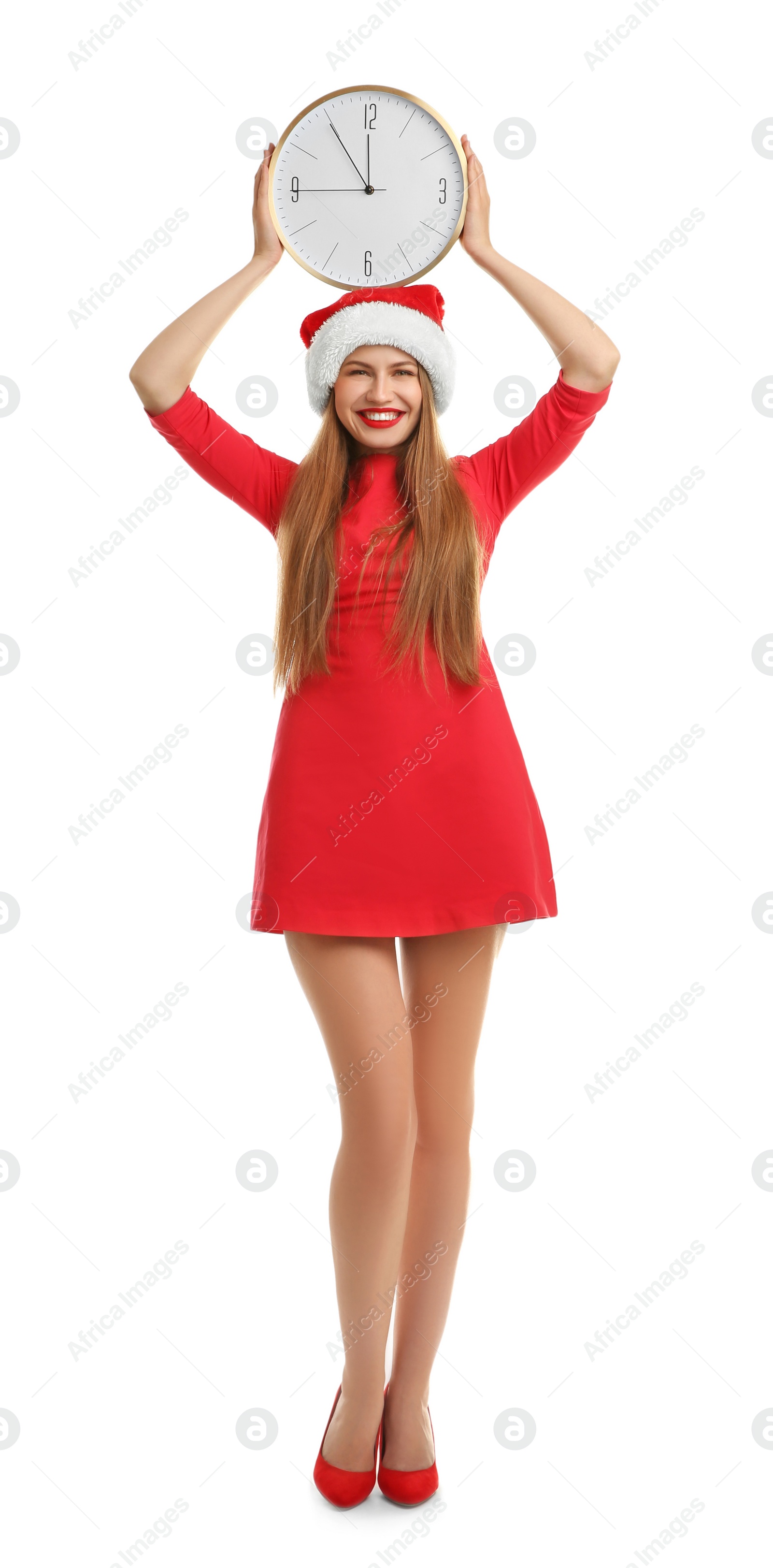 Photo of Young beautiful woman in Santa hat holding big clock on white background. Christmas celebration