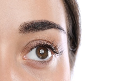 Young woman with beautiful eyelashes on white background, closeup view