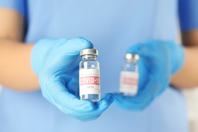 Doctor with coronavirus vaccine in laboratory, closeup