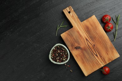 Photo of Wooden cutting board, fresh tomatoes and different spices on grey textured table, flat lay. Space for text