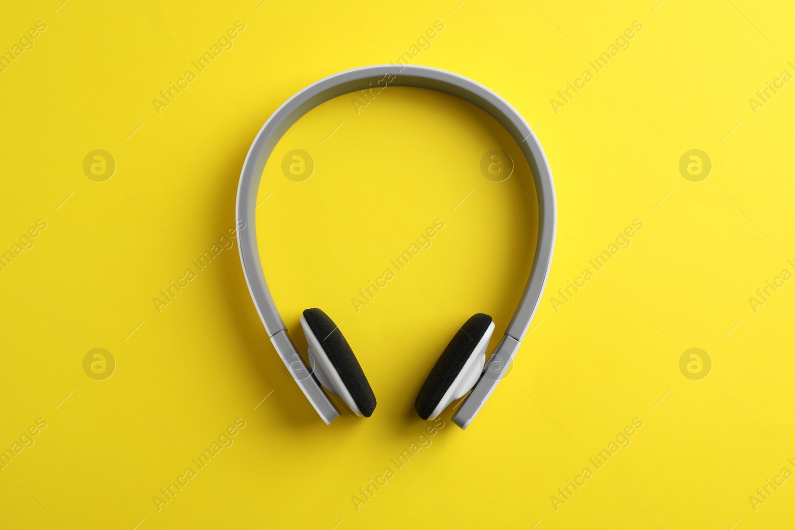 Photo of Wireless headphones on color background, top view