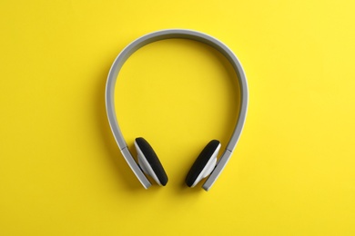 Photo of Wireless headphones on color background, top view